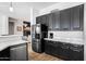 Modern kitchen featuring stainless steel appliances and sleek, black cabinetry at 9545 E Gary St, Mesa, AZ 85207