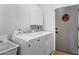 Clean laundry room with washer, dryer, storage cabinet, and a utility sink at 9545 E Gary St, Mesa, AZ 85207