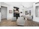 Bright living room featuring a fireplace, plank flooring, and four comfortable chairs at 9545 E Gary St, Mesa, AZ 85207