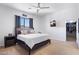 Relaxing main bedroom features neutral carpet, ceiling fan and mounted television at 9545 E Gary St, Mesa, AZ 85207