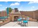 Backyard patio area featuring a fireplace and outdoor dining setup at 9545 E Gary St, Mesa, AZ 85207