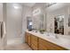 Bathroom featuring double sinks, vanity lighting, and an enclosed shower for convenience at 11360 E Keats Ave # 20, Mesa, AZ 85209