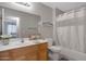 Bright bathroom with a wood vanity, large mirror, and a shower-tub combination with white curtain at 11360 E Keats Ave # 20, Mesa, AZ 85209