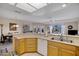 Open concept kitchen featuring wood cabinets, light countertops, and an island with a sink at 11360 E Keats Ave # 20, Mesa, AZ 85209