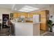 Well-equipped kitchen with light wood cabinetry and breakfast bar at 11360 E Keats Ave # 20, Mesa, AZ 85209