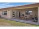 Covered patio space with comfortable seating and a view of the well-maintained yard at 11360 E Keats Ave # 20, Mesa, AZ 85209