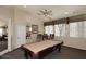 The game room has a pool table with a ceiling fan, and is brightly lit with natural light at 11375 E Sahuaro Dr # 2064, Scottsdale, AZ 85259