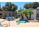 A community hot tub area features a built-in spa and chairs for lounging near the pool at 11375 E Sahuaro Dr # 2064, Scottsdale, AZ 85259