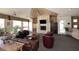 A spacious living room with a fireplace, TV and leather furniture, with a kitchen in the background at 11375 E Sahuaro Dr # 2064, Scottsdale, AZ 85259