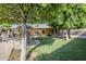 Spacious backyard featuring mature trees, lush lawn, and a covered patio ideal for outdoor living and entertaining at 12434 S Ki Cir, Phoenix, AZ 85044