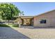 Expansive backyard with covered patio, lush green lawn, and gravel area perfect for entertaining and outdoor activities at 12434 S Ki Cir, Phoenix, AZ 85044