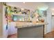 Entertainer's bar with large mirror, decorative lighting, tile floors, and generous counter space at 12434 S Ki Cir, Phoenix, AZ 85044
