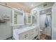 Bathroom features a double sink vanity with mirrors and a toilet in a separate room at 12434 S Ki Cir, Phoenix, AZ 85044