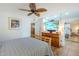 Bright bedroom showcases a ceiling fan and a large dresser under the flat screen TV at 12434 S Ki Cir, Phoenix, AZ 85044
