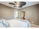 Bedroom features tile floor, ceiling fan, and a decorative bed frame with palm tree accents at 12434 S Ki Cir, Phoenix, AZ 85044