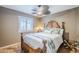Beautiful bedroom with a carved wood bed frame, ceiling fan, and plantation shutters at 12434 S Ki Cir, Phoenix, AZ 85044