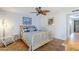 Well-lit bedroom with tiled floor, wooden bed frame, and seating at 12434 S Ki Cir, Phoenix, AZ 85044