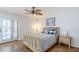 Bedroom features a wooden bed frame, ceiling fan, and access to the outside through french doors at 12434 S Ki Cir, Phoenix, AZ 85044