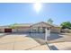 Charming single-story home with a well-maintained front yard and a two-car garage at 12434 S Ki Cir, Phoenix, AZ 85044