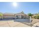 Single-story home featuring low-maintenance desert landscaping, covered entry, and a two-car garage at 12434 S Ki Cir, Phoenix, AZ 85044