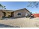 Exterior view showing the covered patio, spacious parking area, and well-maintained backyard of the property at 12434 S Ki Cir, Phoenix, AZ 85044