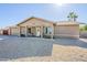 Inviting single-level home with desert landscaping, covered porch, and attached two-car garage at 12434 S Ki Cir, Phoenix, AZ 85044