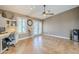 A spacious great room features a ceiling fan, built in desk and French doors at 12434 S Ki Cir, Phoenix, AZ 85044