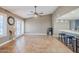 Open concept great room with ceiling fan, French doors and built in desk area at 12434 S Ki Cir, Phoenix, AZ 85044