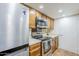 This kitchen features wood cabinets and stainless steel appliances, including a refrigerator and oven at 12434 S Ki Cir, Phoenix, AZ 85044