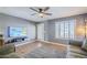 Bright living area featuring tile floors, modern ceiling fan, and plantation shutters allowing natural light at 12434 S Ki Cir, Phoenix, AZ 85044