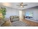 Relaxing living room with ceiling fan, TV, and comfortable seating overlooking a tropical backyard view at 12434 S Ki Cir, Phoenix, AZ 85044