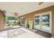 The covered patio shows tile flooring, outdoor seating and access to the backyard at 12434 S Ki Cir, Phoenix, AZ 85044