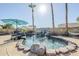 Beautiful pool with a rock waterfall feature and surrounding tropical landscaping for a serene retreat at 12434 S Ki Cir, Phoenix, AZ 85044