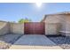 Gated side yard with concrete block walls, gravel ground cover, and a wood privacy gate at 12434 S Ki Cir, Phoenix, AZ 85044