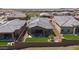 Aerial perspective of a home with a patio, artificial turf, and desert surroundings, offering a private backyard at 13162 W Golden Puma Trl, Peoria, AZ 85383