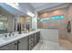 Elegant bathroom featuring double sinks, white countertops, and a spacious glass-enclosed shower at 13162 W Golden Puma Trl, Peoria, AZ 85383