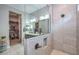 Stylish bathroom with glass shower, vanity, and access to a well-organized walk-in closet at 13162 W Golden Puma Trl, Peoria, AZ 85383