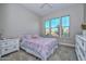 Bright bedroom with large windows, floral bedding, and matching bedside tables at 13162 W Golden Puma Trl, Peoria, AZ 85383