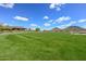 Manicured green space surrounded by desert landscaping and mountain views at 13162 W Golden Puma Trl, Peoria, AZ 85383