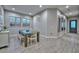 Bright dining room with wood-look tile flooring, a modern table set, and abundant natural light from large windows at 13162 W Golden Puma Trl, Peoria, AZ 85383