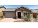 Charming front exterior with desert landscaping, a tile roof, and a welcoming covered entrance at 13162 W Golden Puma Trl, Peoria, AZ 85383