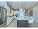 Spacious kitchen features stainless steel appliances, a kitchen island with breakfast bar, and ample cabinet space at 13162 W Golden Puma Trl, Peoria, AZ 85383