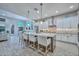 Open-concept kitchen boasts a large center island with seating, stainless steel appliances, and stylish pendant lighting at 13162 W Golden Puma Trl, Peoria, AZ 85383
