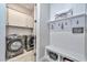 Convenient laundry room with modern washer and dryer, storage cabinets, and decor at 13162 W Golden Puma Trl, Peoria, AZ 85383