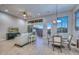 Inviting living room featuring a dining area, TV, and access to the covered outdoor patio at 13162 W Golden Puma Trl, Peoria, AZ 85383