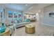 Bright living room and kitchen area, featuring modern furnishings and sleek tile flooring at 13162 W Golden Puma Trl, Peoria, AZ 85383