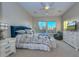 Comfortable main bedroom featuring soft carpet, large windows, and decorative beddings at 13162 W Golden Puma Trl, Peoria, AZ 85383