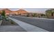 Scenic street view showcasing well-maintained homes, desert landscaping, and the backdrop of rolling mountains at 13162 W Golden Puma Trl, Peoria, AZ 85383