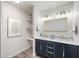 Stylish bathroom featuring a double vanity with marble countertop and a gold trimmed mirror at 1427 W 6Th Dr, Mesa, AZ 85202