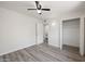 Clean bedroom featuring wood flooring, a ceiling fan, and a spacious closet at 1427 W 6Th Dr, Mesa, AZ 85202